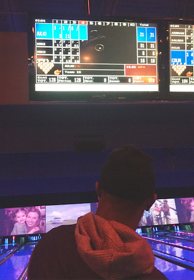 Credit: @CoachMcCartan Atlanta Falcons WR Julio Jones checks his score before taking the lane at Rally at the Alley.